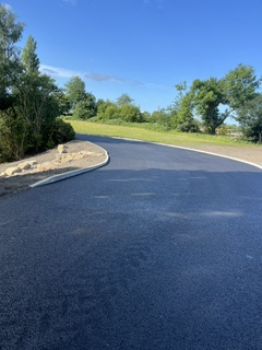 Man-Made Waterfall, Curbs & Roadwork — Finished Tarmac